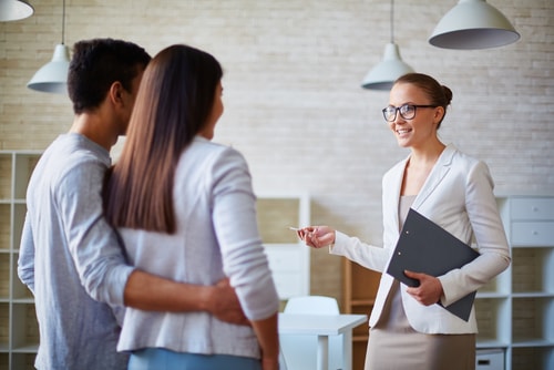 Woman realtor talking to a young family